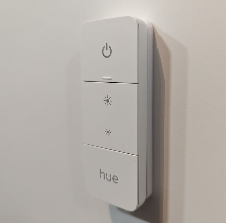 Invisible holder for the Philips Hue Dimmer Switch v2. Magnetic holder for the dimmer, fastened using NanoTape. image 1