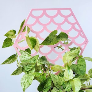 May include: A handmade wooden sign displaying the word "Welcome" in a whimsical font. The white-painted sign has a distressed finish and a small heart detail. Suitable for indoor or outdoor display.