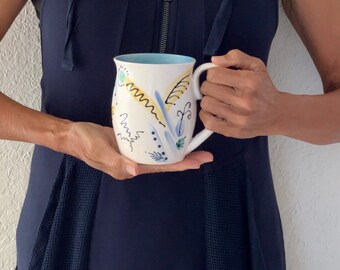 Artisan Mug! Hand-painted ceramic mug with a modernist floral design and a Tuscan blue color on the inside.