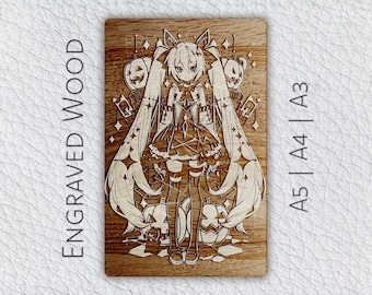 May include: A wood-burned image of a cartoon character with long blue hair, wearing a black and white dress, surrounded by pumpkins and stars. The image is on a wooden background and has the text "A5 | A4 | A3" on the right side.