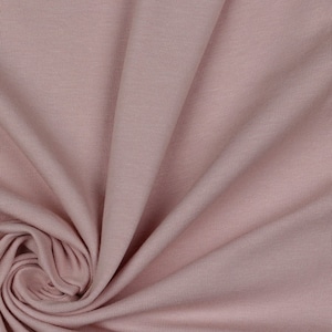 May include: Close-up of a soft, pink ribbed fabric. The fabric is smooth and has a subtle sheen.