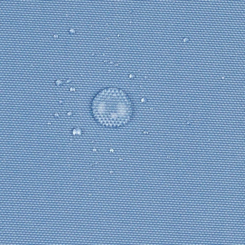 May include: A light blue, tightly woven fabric surface featuring a visible grid-like texture. Several clear water droplets of varying sizes are scattered across the material, demonstrating a water-repellent or hydrophobic quality.