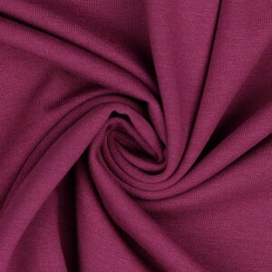 May include: Close-up of a deep burgundy ribbed fabric. The fabric is soft and has a subtle texture.