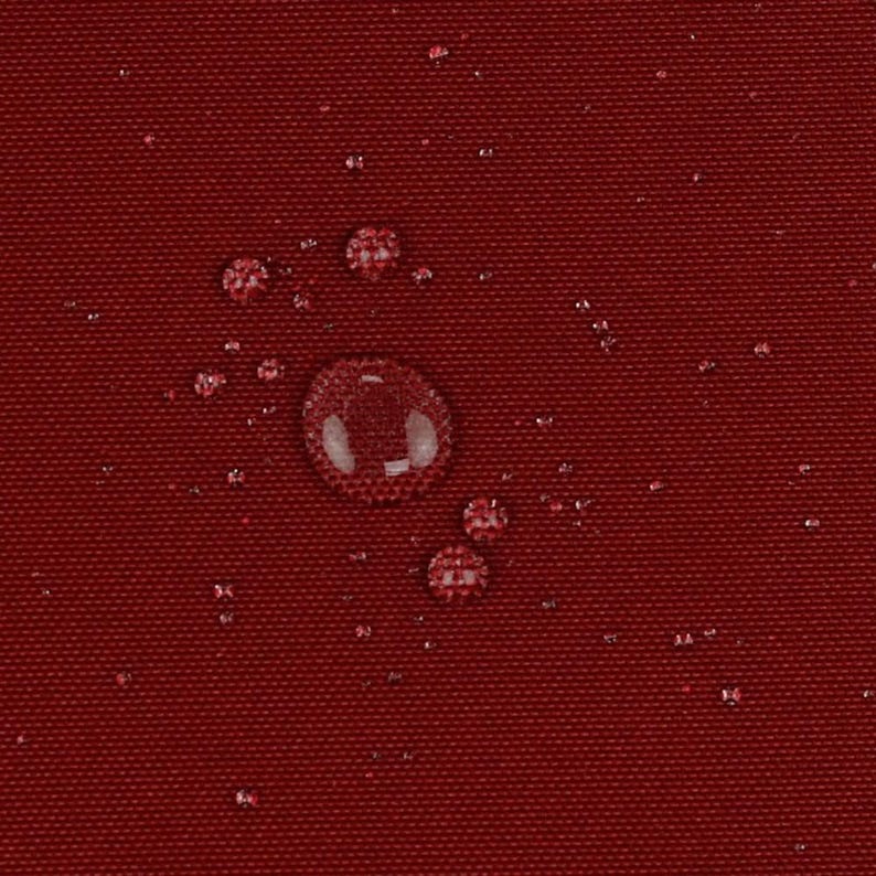May include: A deep red, tightly woven fabric surface featuring a water-repellent finish. Multiple clear water droplets of varying sizes are scattered across the textured material, creating a beaded effect on the dark crimson textile background.