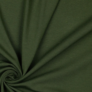 May include: Close-up of a dark green fabric with a ribbed texture. The fabric is folded and draped, showing its soft and flexible nature.
