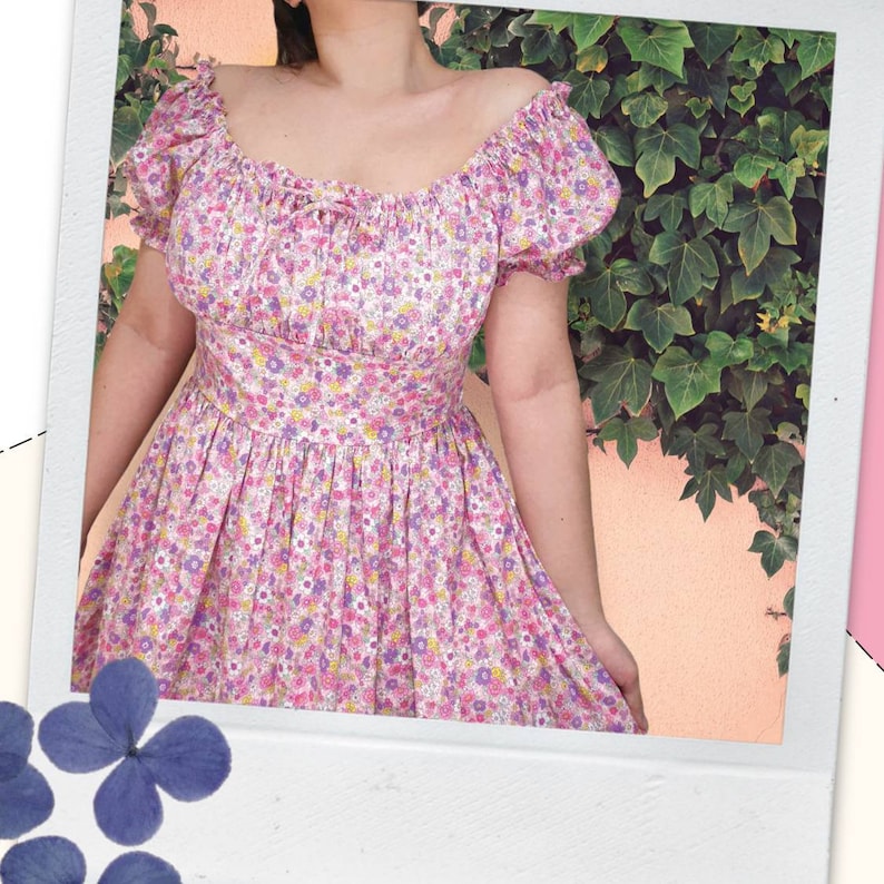 May include: A pink and white floral print dress with a square neckline and short puff sleeves. The dress has a fitted bodice and a flowing skirt.