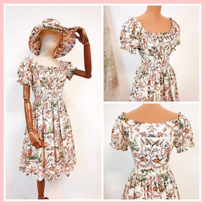May include: A white dress with a floral print and a ruffled neckline. The dress has short sleeves and a fitted bodice. The dress is cinched at the waist and has a flowing skirt.