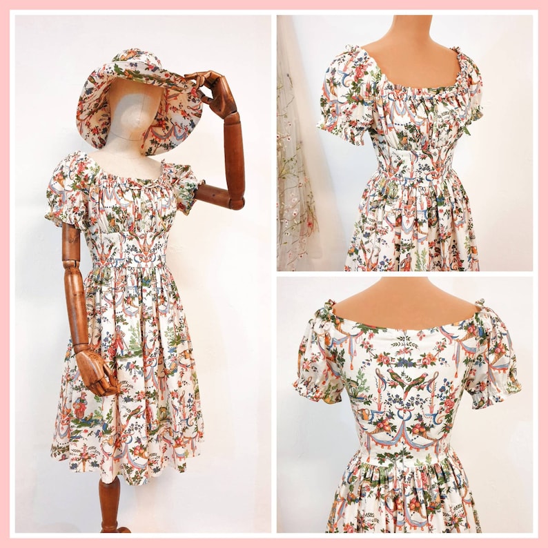 May include: A white dress with a floral print and a ruffled neckline. The dress has short sleeves and a fitted bodice. The dress is cinched at the waist and has a flowing skirt.