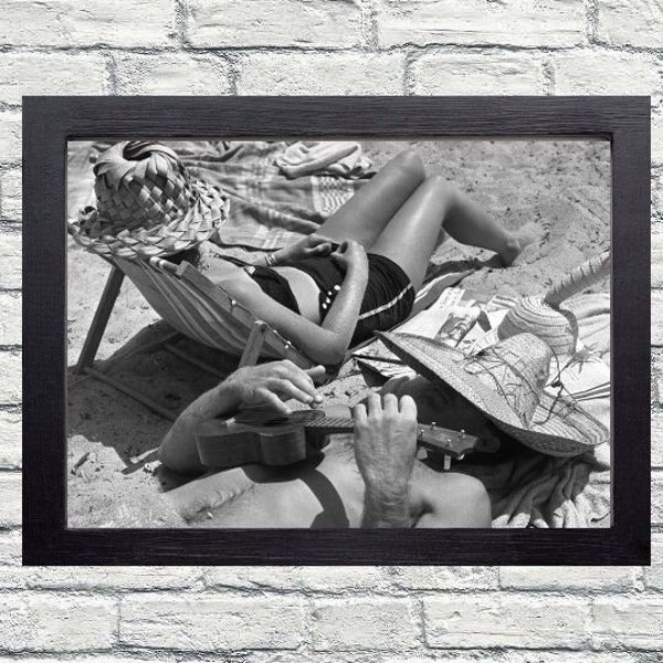 Vintage beach life photograph - summer photo prints - retro boho posters - A woman and a man in California in July 1950 tanning on the beach