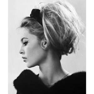 May include: Black and white portrait photograph of a woman with a bouffant hairstyle. She is wearing a black fur collar and a thin gold necklace. The image is 27 x 35 cm or 11 x 14 inches.
