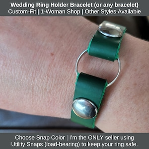 Peut inclure: Un bracelet en cuir vert avec un anneau argenté et deux boutons-pression argentés. Le bracelet est conçu pour tenir une bague en toute sécurité.