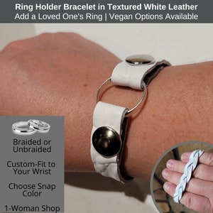 May include: White textured leather ring holder bracelet with a silver ring and snap closure. The bracelet is designed to hold a ring. The text on the image says "Ring Holder Bracelet in Textured White Leather".