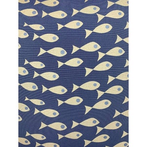 May include: A navy blue fabric featuring a repeating pattern of cream-coloured fish. Each fish has a blue eye and is arranged in a seemingly random, yet organised, layout. The fabric has a textured appearance.