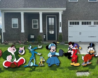 May include: A collection of cartoon characters from Disney's "Mickey's Christmas Carol" are displayed on a lawn in front of a house. The characters include Scrooge McDuck, Mickey Mouse, Minnie Mouse, and others, all in their animated attire.