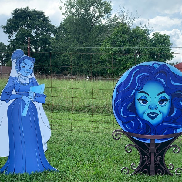 May include: Two blue ghost figures stand in a grassy field. The figure on the left is a woman holding an axe. The figure on the right is a woman's face inside a blue orb.