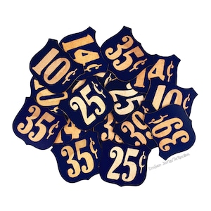 May include: A collection of blue and gold price tags with various denominations, including 10c, 25c, and 35c. The tags are shaped like shields and have a vintage aesthetic.
