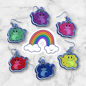 May include: Six pairs of rainbow-colored bear-shaped earrings with a silver hook. Each bear is a different color: purple, pink, green, red, yellow, and blue.