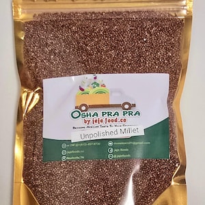 May include: A gold resealable bag filled with unpolished millet grains. The bag has a label that reads "OSHA PRA PRA by jeje food.co Bringing African Taste To Your Door Unpolished Millet".