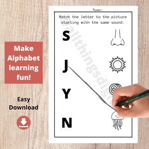 May include: Black and white printable worksheet for children to match letters to pictures. The letters are S, J, Y, and N. The pictures are a nose, sun, jellyfish, and a target.