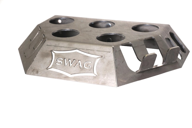 May include: A silver metal stand with six circular cutouts and the word "SWAG" cut out in the center. The stand has three tabs on the side.