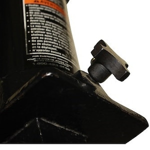 May include: Close-up of a black hydraulic jack with a square base and a black handle with a star-shaped knob. The jack is designed for lifting heavy objects.