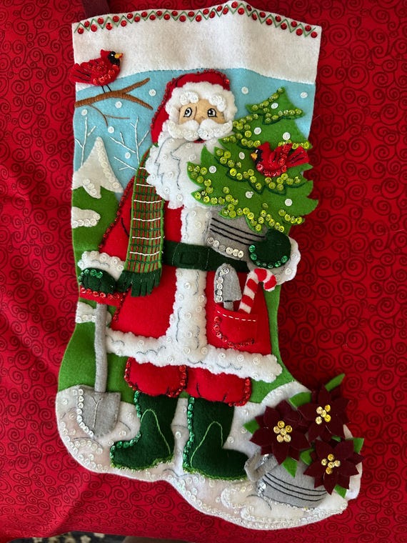 This is a handmade 18" bucilla "Santa Gardening Magic" Stocking