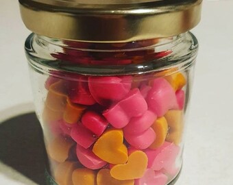 Mini heart wax melts in a jar.