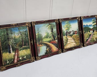 May include: Four framed landscape paintings with ornate burgundy and gold frames. The paintings depict scenes of nature, including trees, paths, and bodies of water. The artwork is displayed against a white background.