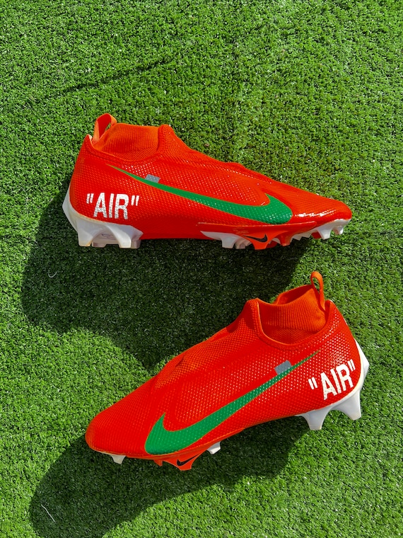 orange and green football cleats