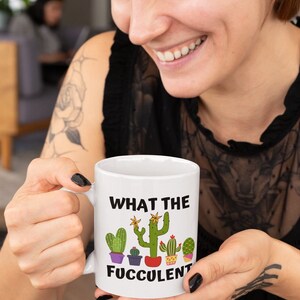 May include: White ceramic mug with a green cactus graphic and the text "What the Fuccolent".