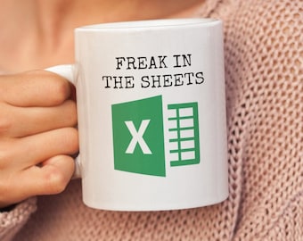 May include: White coffee mug with the text "Freak in the sheets" and a green Microsoft Excel logo.