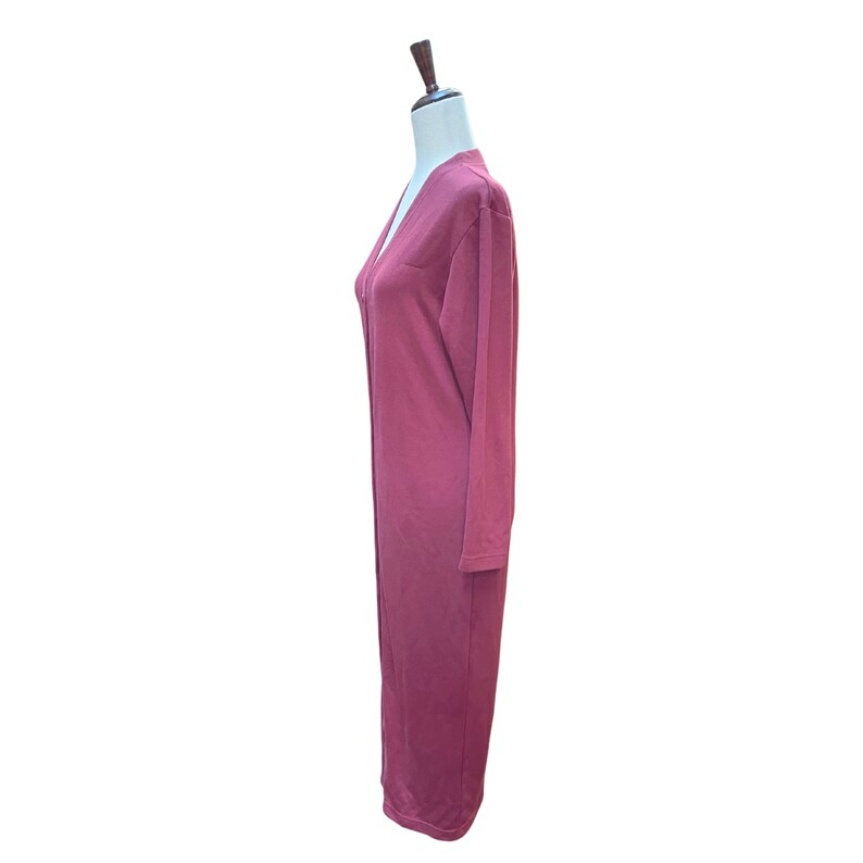 May include: A long, burgundy-colored cardigan dress with long sleeves. The dress has a V-neckline and a relaxed fit. The garment is displayed on a mannequin against a white background. The dress appears to be made of a soft, comfortable material.