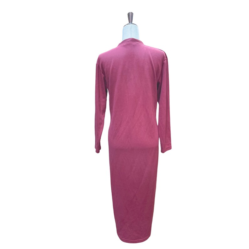 May include: A long-sleeved, burgundy-colored dress. The dress has a high neckline and a form-fitting silhouette that extends to the ankles. The dress is displayed on a mannequin against a white background.