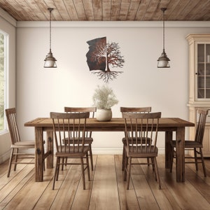 May include: A rustic wooden dining table with six chairs, set in a room with a white wall and wooden ceiling. A metal tree sculpture hangs on the wall above the table.