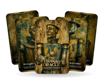 May include: A deck of oracle cards featuring illustrations of the Tin Man from The Wizard of Oz. The central card displays the Tin Man with the text "The Tin Man Oracle Heartfelt Wisdom". Other cards show similar characters.