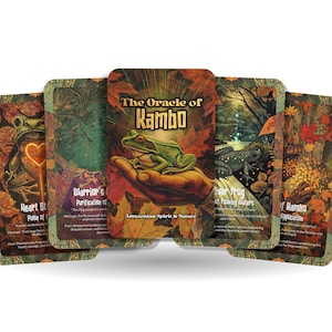 May include: The Oracle of Kambo deck of cards featuring illustrations of frogs, leaves, and nature scenes. The cards have a rustic, earthy color palette with text on each card. The central card displays a green frog on a hand.