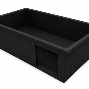 May include: A rectangular matte black sink basin featuring a deep interior and a flat rim. The front side of the sink includes a recessed square panel detail, providing a clean and uniform appearance for this functional kitchen or utility fixture.