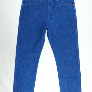 May include: A pair of blue denim jeans with a straight leg fit. The jeans have a classic five-pocket design and a button fly.