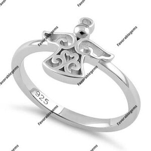 May include: Sterling silver ring featuring a delicate angel design. The ring is marked with "925" on the inside band.