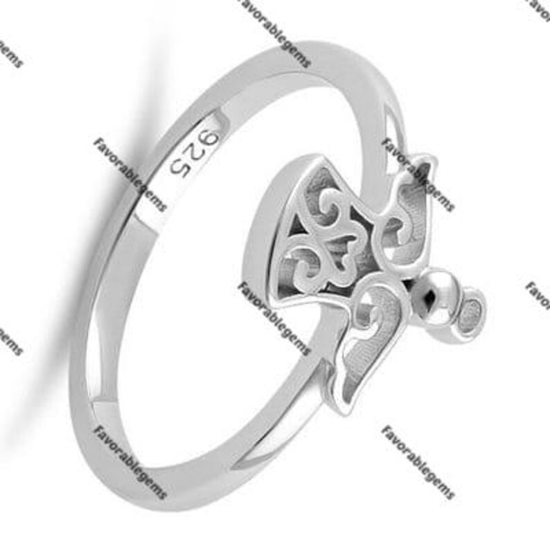 May include: Silver ring with a detailed angel design. The ring is marked with "925" on the inside band.