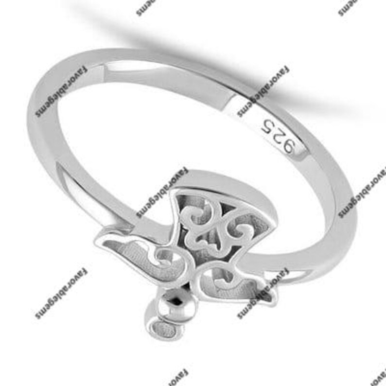 May include: A silver ring with a delicate, ornate design. The ring is marked with the number "925", indicating it is made of sterling silver.