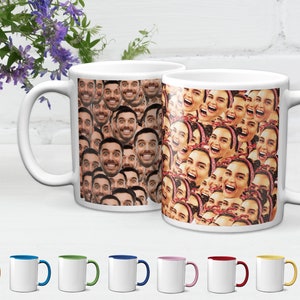 May include: Two white ceramic mugs with a pattern of colorful faces. The mugs have a handle on the right side. The mugs are on a white surface.