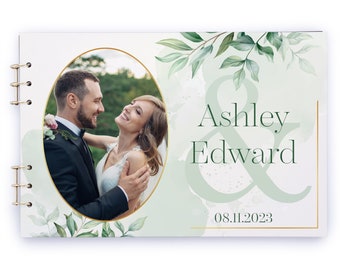 May include: A wedding guest book with a green and white watercolor background. The cover features a photo of a couple in a green setting, with the text "Ashley & Edward" and the date "08.11.2023".