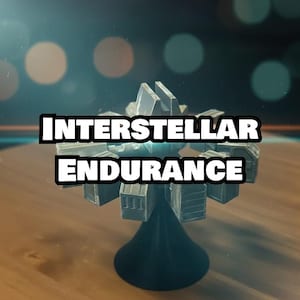 May include: A model of the Interstellar Endurance spaceship, featuring a central hub with multiple rectangular modules. The model is silver and black, with the text "INTERSTELLAR ENDURANCE" in bold white letters. The model sits on a wooden surface.