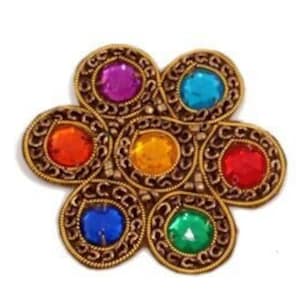 May include: A gold-toned flower-shaped brooch with six colorful rhinestones. The rhinestones are red, orange, yellow, green, blue, and purple.