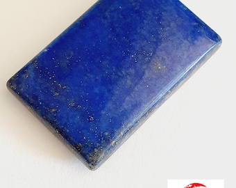 May include: A rectangular piece of polished lapis lazuli with a deep blue colour and gold flecks. The stone has a smooth, polished surface.