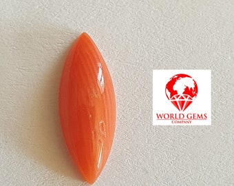 May include: A bright orange, teardrop-shaped coral gemstone. The gemstone has a smooth, polished surface and a pointed tip.