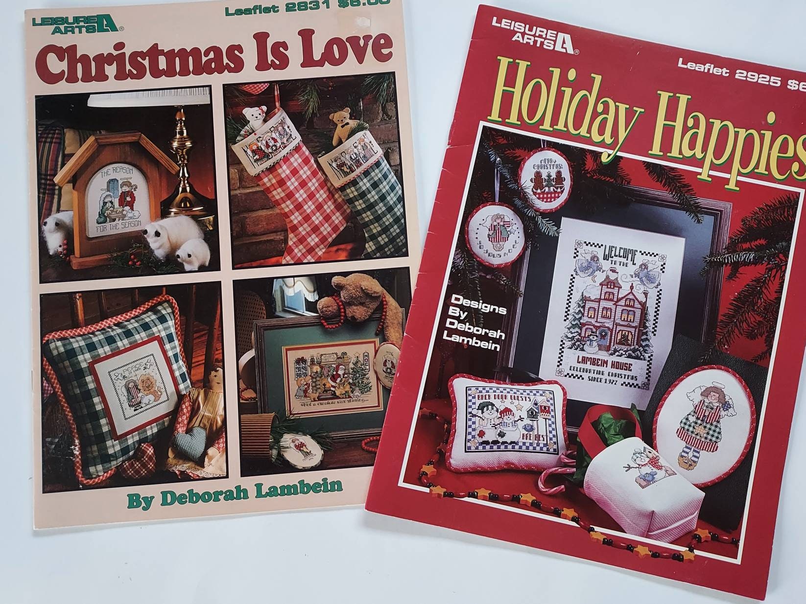 2 leisure arts leaflets featuring holiday cross stitch