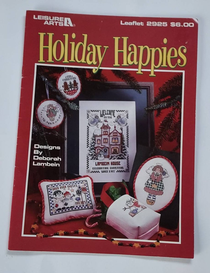2 leisure arts leaflets featuring holiday cross stitch