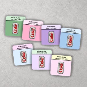 May include: Seven square coasters featuring pastel backgrounds and a Diet Coke can illustration. Each coaster displays the text RESERVED FOR followed by a name: Phil, Lucy, Lola, Dave, Molly, Skye, or Willow, and the phrase DIET COKE.